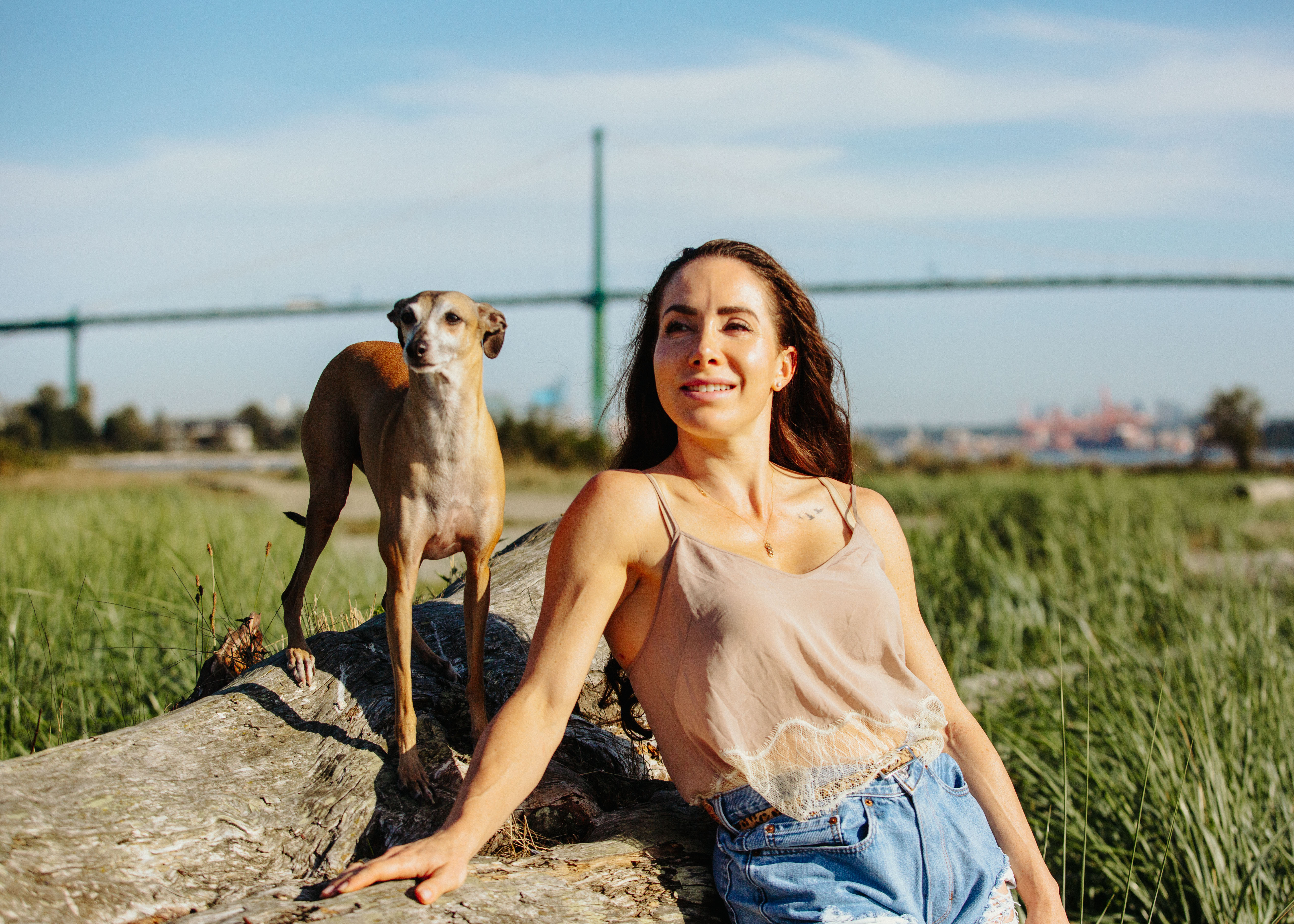 Sarah outdoors at golden hour with her dog